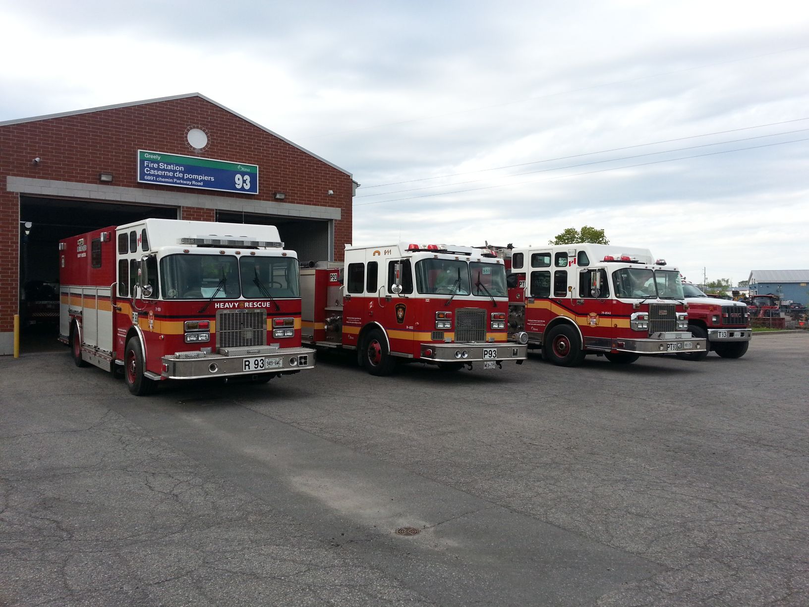 Exterior view of the red-brick rural City of Ottawa Fire Station 93, featuring three fire trucks.